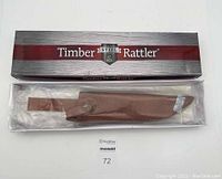 Timber Rattler cutter in original box with leather sheath inside plastic wrap.