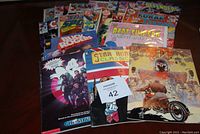 Photo of assorted comics including DC Space comics, Bart Simpson and Buck Rogers among others