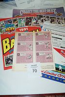 Photo of various promotional flyers and order forms for baseball and hockey sports cards spread out on a surface.