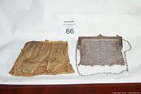 Photo showing two vintage metal clutch purses, gold-toned on left and silver-toned on right, on white background.