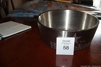 Front angle showing the Heineken logo on the ice bucket with the lot number card placed in front.