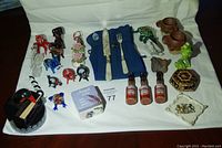 Overview of all items including blown glass figurines, fried egg fork and knife set, crow toothpick holder, mini sauce bottles, and curio boxes.