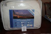 Packaged Twin White Goose Down Comforter with label showing 230 thread count and oversized dimensions.