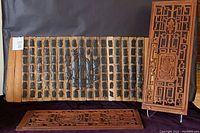 Photo showing full view of lot with bamboo carving and two carved wood panels.
