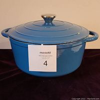 Photo of the Dutch oven with lid on, showing teal blue exterior and silver knob.
