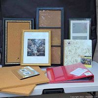 Overall shot of all items on a table showing frames, corkboards, and scrapbooks together