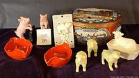 Full lot of mixed animal-themed collectible kitchen and decorative items displayed together on dark cloth.