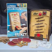 Vintage Frenzy game beside original box, wooden ping pong paddles and game instructions visible