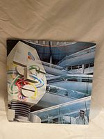 Front cover of vinyl record showing Alan Parsons Project artwork with futuristic building and colorful elements