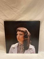 Front cover of Angel Olsen vinyl record showing a portrait photo of Angel Olsen against a dark background.