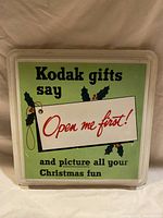 Front-facing photo of the Kodak retro advertising decoration sign showing text and holly decoration