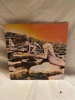 Front cover image showing children climbing on rocky terrain under an orange sky.