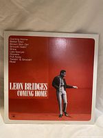 Front cover of Leon Bridges Coming Home vinyl record showing artist image and track titles.