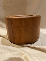 Side view of round teak wood ice bucket showing wood grain and smooth finish.