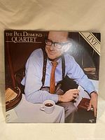 Front of the vinyl album cover showing Paul Desmond seated at a table with a cup of coffee.
