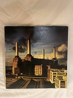 Front cover of Pink Floyd Animals vinyl record showing Battersea Power Station at dusk.