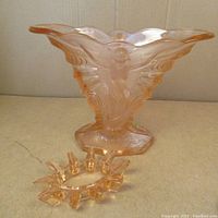 Full view of the peach/orange vase and star-shaped insert showing the overall shape and design.