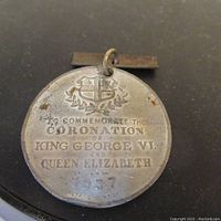 Reverse side showing inscription and shield emblem commemorating the 1937 coronation.