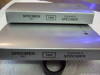 Photo of the edge of two specimen sets showing the years 1993 and 1995 with bilingual labeling Specimen Set/Ensemble Spécimen.