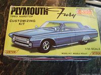 Top of box showing blue 1963 Plymouth Fury illustration and branding.