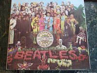 Front cover of The Beatles' Sgt. Pepper's Lonely Hearts Club Band album with famous colorful collage artwork.