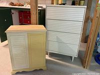 Photo of painted wood two-door cabinet with one white door and one yellow door beside a white dresser.