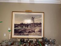 Front side view of framed signed black and white photograph with attached overhead light