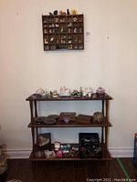 Photo showing entire bookcase with figurines and assortment of items on all shelves