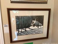 Front view of framed watercolour painting depicting cabin in a snowy forest