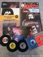 Photo showing Harry Chapin and Gordon Lightfoot albums, plus 4 vinyl singles in front.