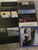 Stack of vinyl LPs including Crosby, Stills, Nash & Young, two Billy Joel titles, Supertramp, Doobie Brothers, Pat Benatar.