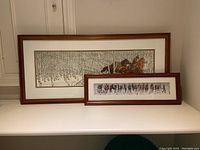 Both framed prints side by side on a white surface