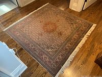 Full angled view of entire carpet on hardwood floor