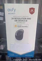 Photo of Eufy indoor security camera boxed packaging showing product and key features including 2K resolution, on-device AI, and Apple HomeKit compatibility.