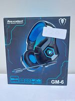 Front view of Beexcellent GM-6 Pro Gaming Headset box showing the headset image, brand, and model with LED-lit ear cups and boom mic.