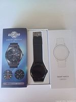 GOKOO Smart Watch in box with black strap, shown with outer packaging and user manual box.