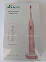 Front side of boxed Safcare Sonic Electric Toothbrush showing product image, basic features, and model number SC-201.