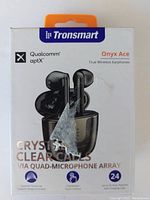 Front of the box showing Tronsmart branding, product name Onyx Ace, Qualcomm aptX logo, features such as crystal clear calls via quad-microphone array, and 24-hour playtime.