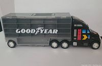 Side view of the grey trailer with Goodyear logo and wheels