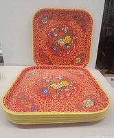 Stack of 11 square vintage metal trays with red crackle and multi-floral design.