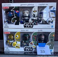 Front view of all six Mini Muggs figures in original Target exclusive packaging, showing Cad Bane, General Grievous, Captain Rex on top row and Bossk, Boba Fett, IG-88 on bottom row.