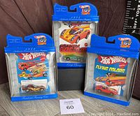 Photo showing all three Hot Wheels 30 Year Limited Edition cars in original sealed packaging: 1975 Large Charge, 1982 Firebird Funny Car, and 1976 Corvette Stingray.