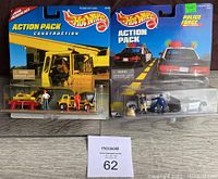 Photo of two Hot Wheels Action Packs: Construction with cement mixer and figures on left; Police Force with police car, armored truck, and figures on right, all sealed in original packaging.
