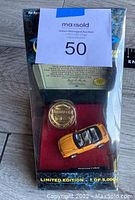 Front view of the boxed limited edition Matchbox Gold Collection Mustang Cobra diecast model in orange with certificate and gold medallion, sealed in original packaging.