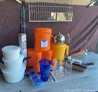Photo of entire set showing various kitchen items including containers, pitcher, teapot, grinder, mandolin, and other miscellaneous items.