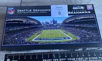 Top view of the sealed new box showing Seattle Seahawks panoramic stadium puzzle image and NFL branding.