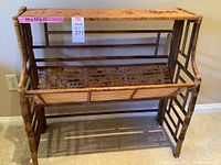 Full front view showing entire bamboo shelf with two storage levels and angled front panel.