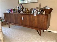 Full view of teak sideboard with decorative items on top