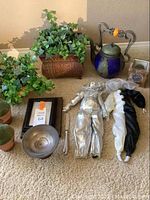 Overall view of all items including potted plants, teapot, clown dolls, frame, decorative bowl