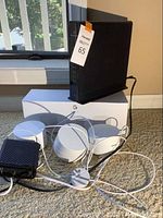 Google Wi-Fi system showing three white mesh units and black Arris modem with cables